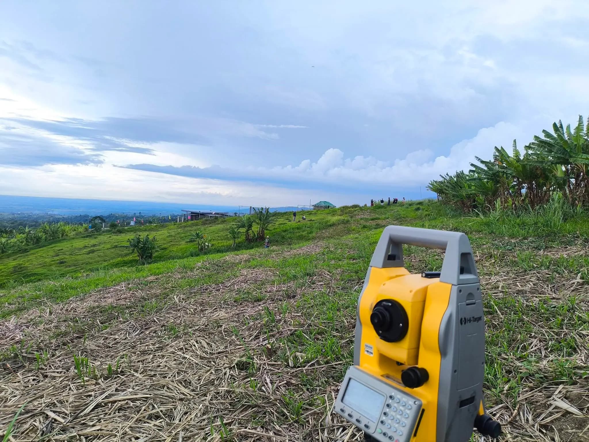 Leonor Surveying Services total station on a hilltop in Silay with a wide view of the lowlands