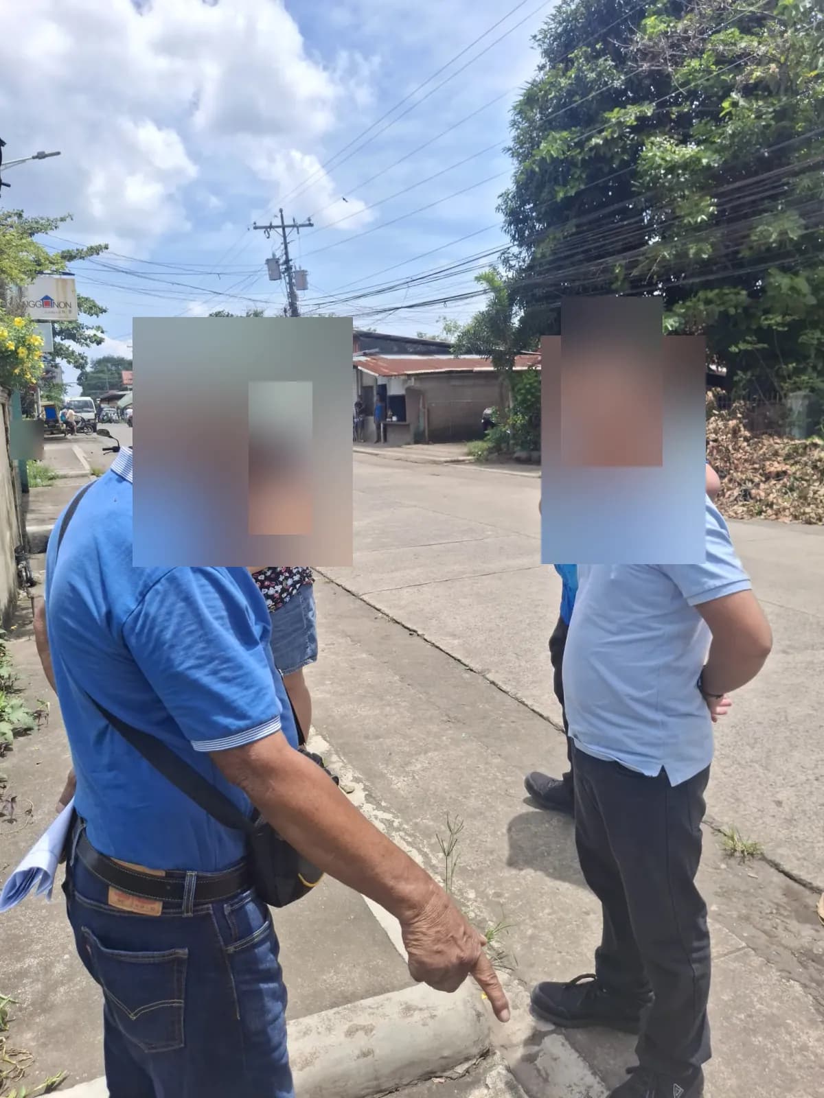 People discussing a curbside ground position beside the neighborhood street